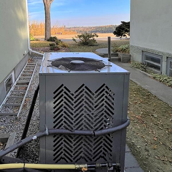 SMTI's Anesi gas heat pump installed near a home