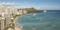 View of Waikiki beach and Honolulu cityscape with Diamond Head in the background on a sunny day.