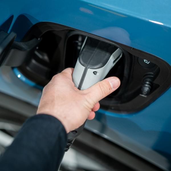 Person charging an electric car