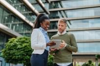 Diverse business people in financial district in front of sustainable building