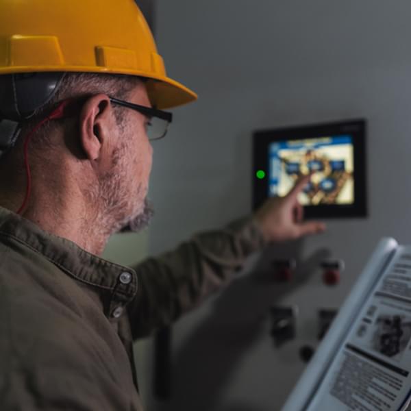 Energy engineer works on digital tablet to maintain heating and cooling.