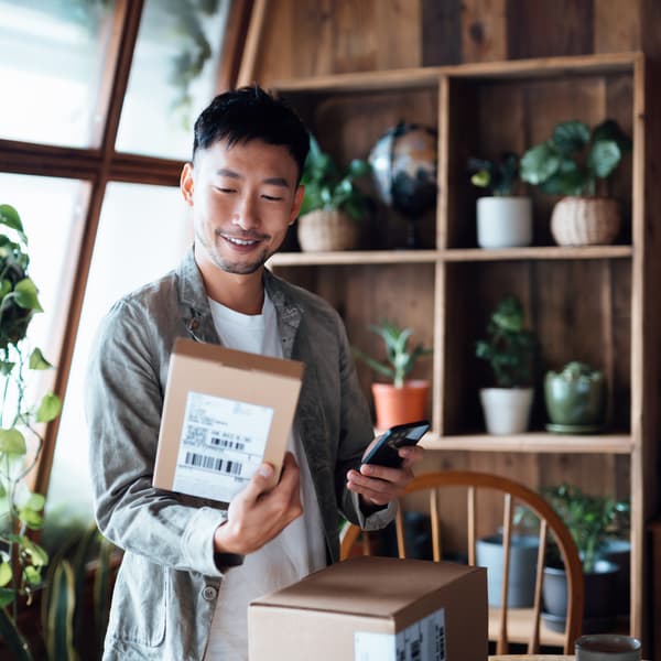 Happy Asian man receiving online energy efficiency product purchases