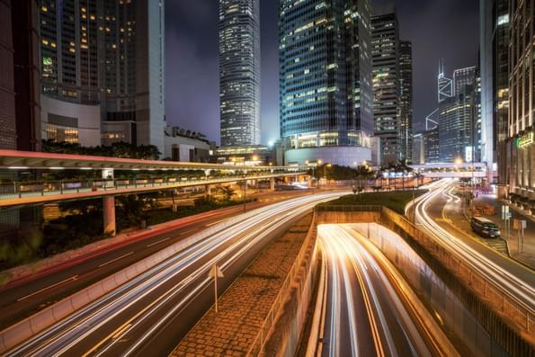 Urban traffic with cityscape at night in busy city