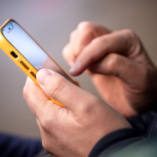 Smartphone in male hands. Close up of hands with a phone.