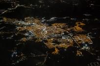 Aerial view of small town with lights on at night.