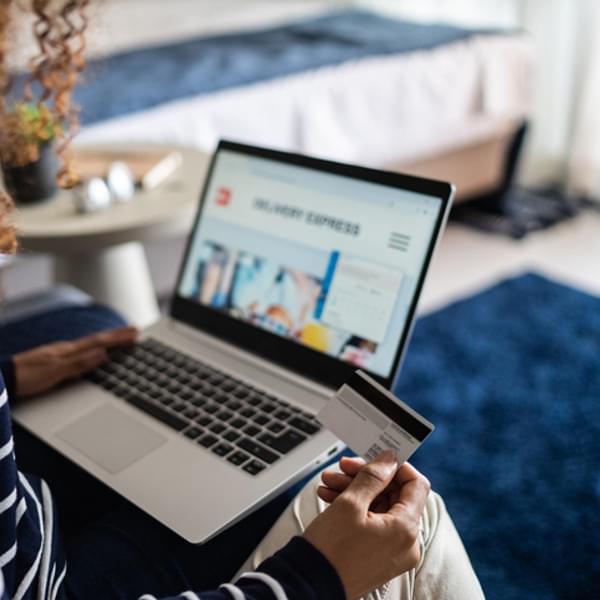 Young woman online shopping using the laptop at home