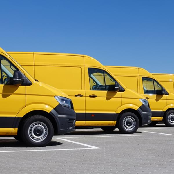 Yellow electric delivery vans in a row.