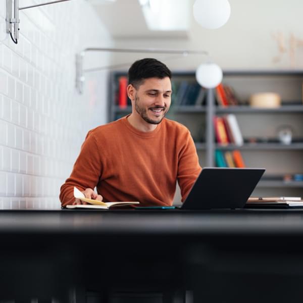 Happy businessman working on his laptop.