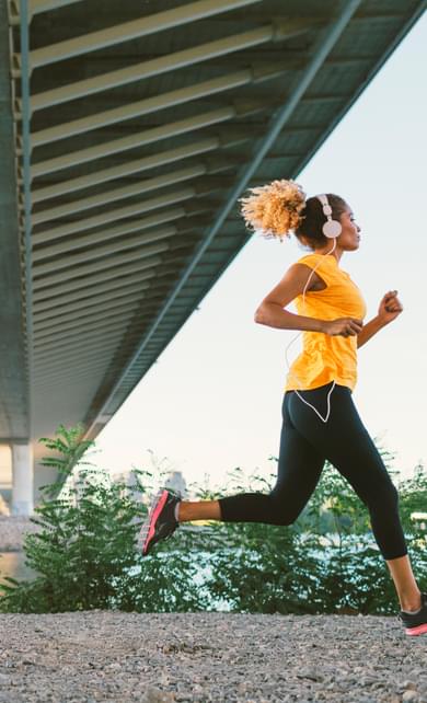 African American woman on a run while listening to music
