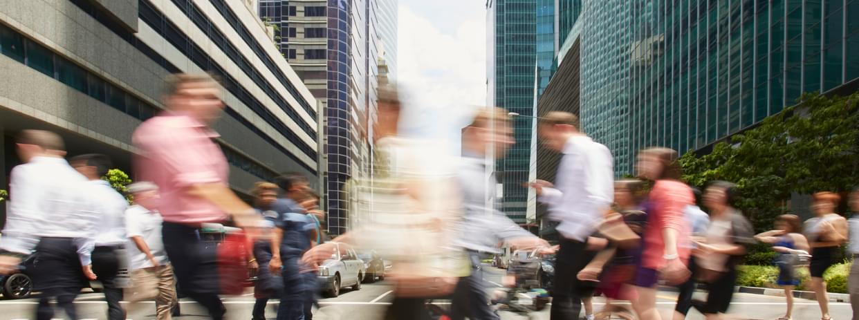 time-lapse of people hurriedly crossing a busy crosswalk in an intersection