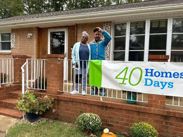 Residential utility customers poses in front of their home