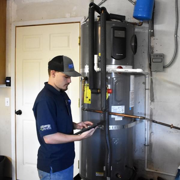 Male technician installing a heat pump water heater (HPWH)