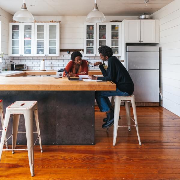 Energy advisor visiting a young woman, suggesting residential energy efficiency and sustainability strategies.
