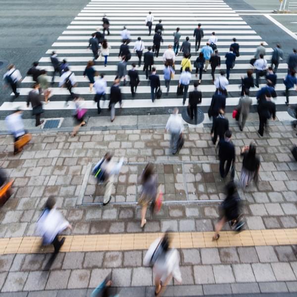 time lapse of a busy crosswalk crowded with people crossing the street