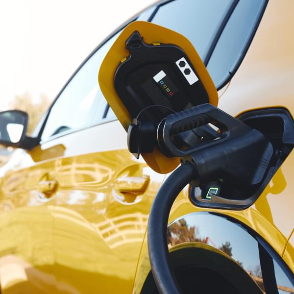 Close up view of a power supply plugged into an electric vehicle.