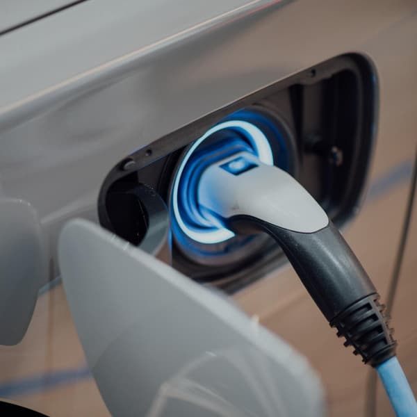 close up shot of an electric vehicle plugged in and charging