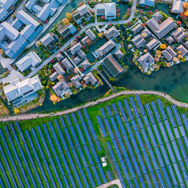 Solar power station beside modern city buildings.