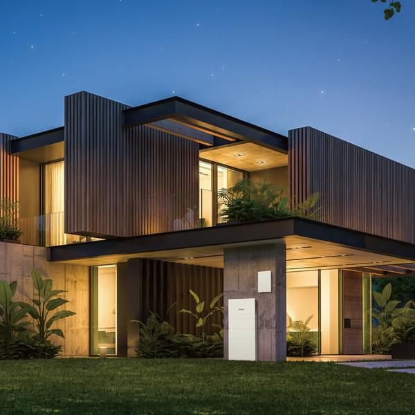 nice modern day home lit up at dusk