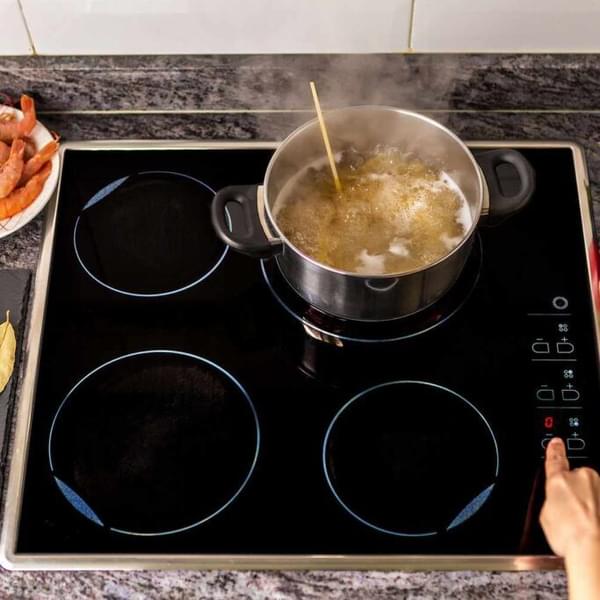top-down view of someone boiling pasta on a stovetop
