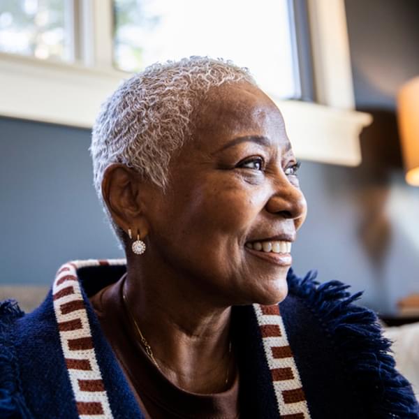 smiling senior woman sitting in her home