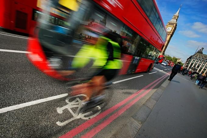 Busy traffic and cyclist on urban London road - air poulltion and emissions