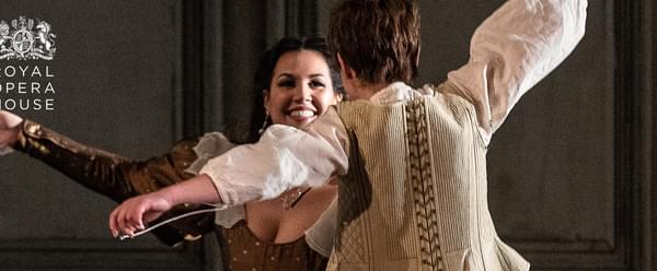 Two people dancing around eachother smiling