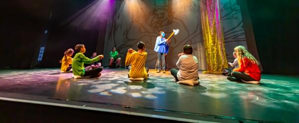 A group of children perform on a stage