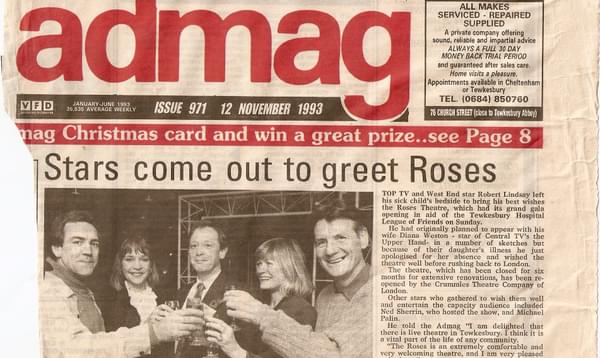 A newspaper clipping showing a group of people celebrating
