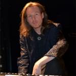 An image of Oliver Wakeman seated at a keyboard