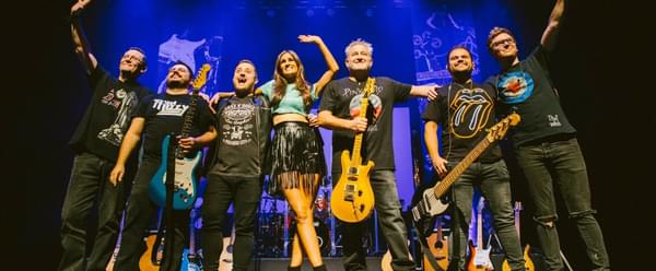 The cast of the "Ultimate Classic Rock Show" take a curtain call on stage