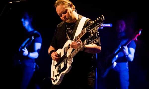 A man plays a guitar