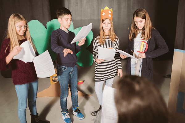 A small group of young teens rehearse a play