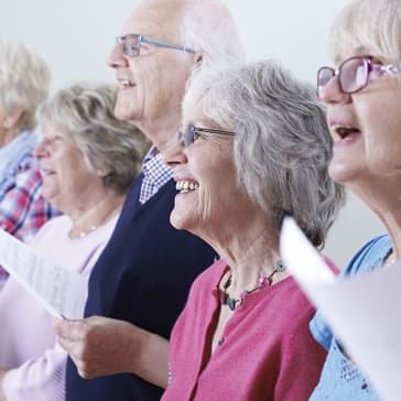 A group of older people singing