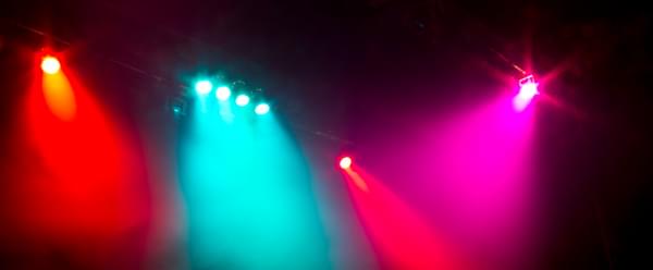 Bright stage lights against a dark background