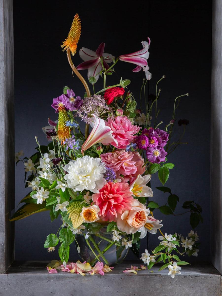 Image of a bright and colourful floral bouquet on a dark background.