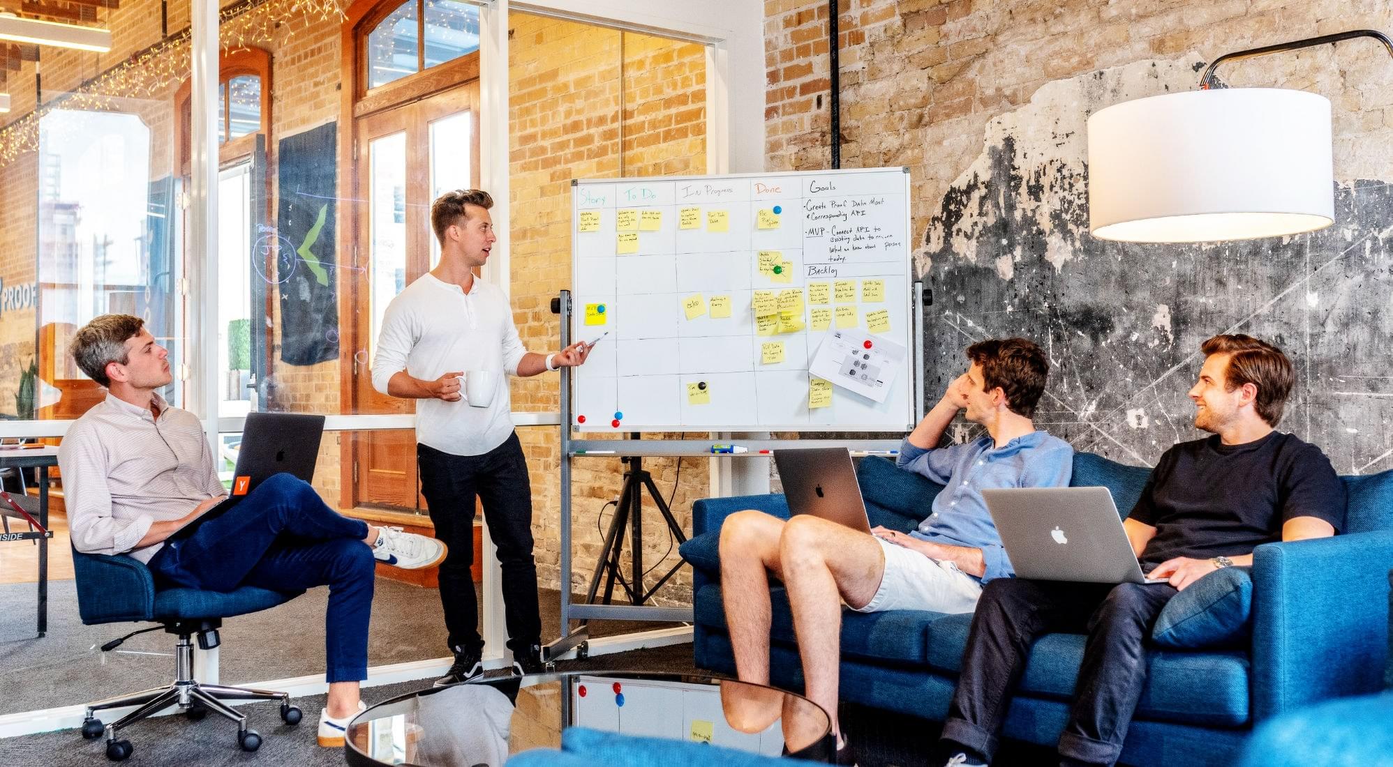 Employees seated while team leader gives presentation for marketing strategy
