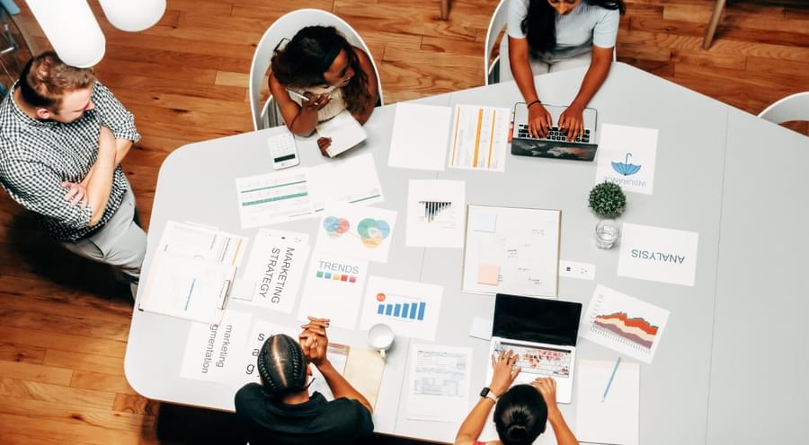 Overhead shot of team working on marketing strategy in an office