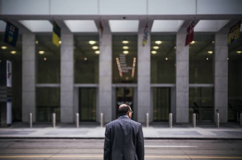 Business man standing in front of building