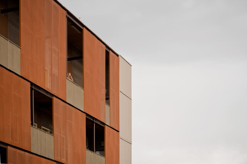 The outside of a building with a person on the balcony