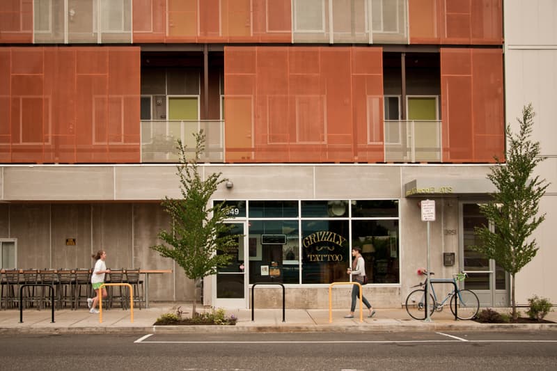 People walking by a building