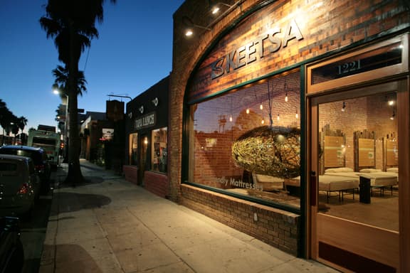 The outside of a retail shop at dusk