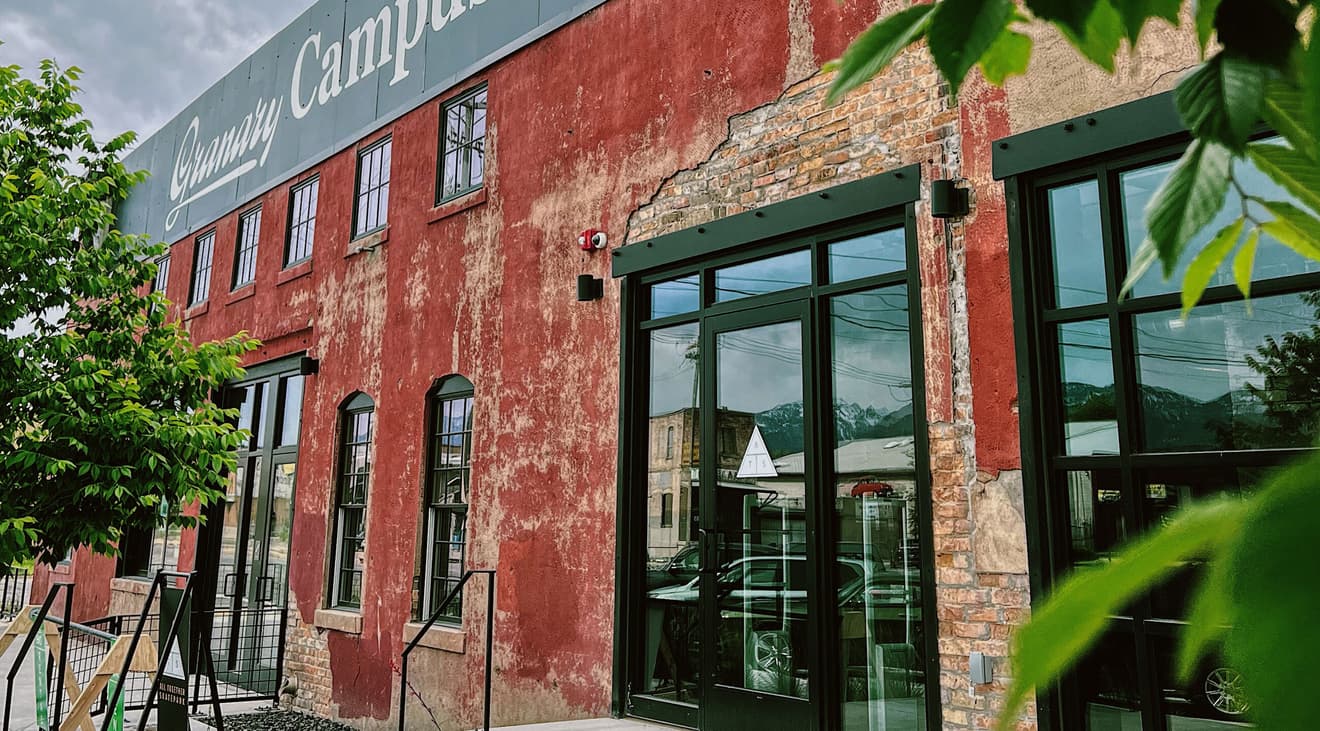 An exterior shot of the Granary Campus building with trees flanking both sides.
