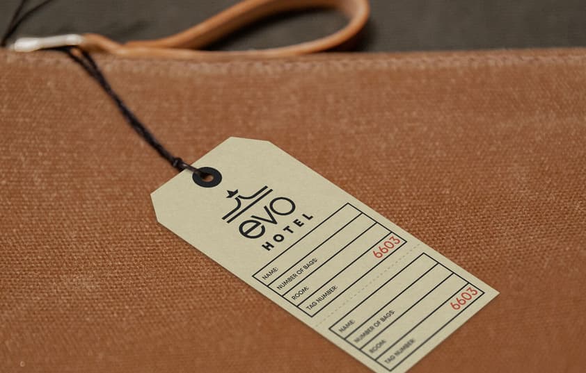 A close-up of an EVO Hotel bag tag.