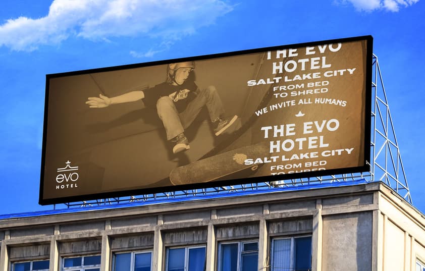 A shot of a billboard with a skater and one of the EVO Hotel logos.