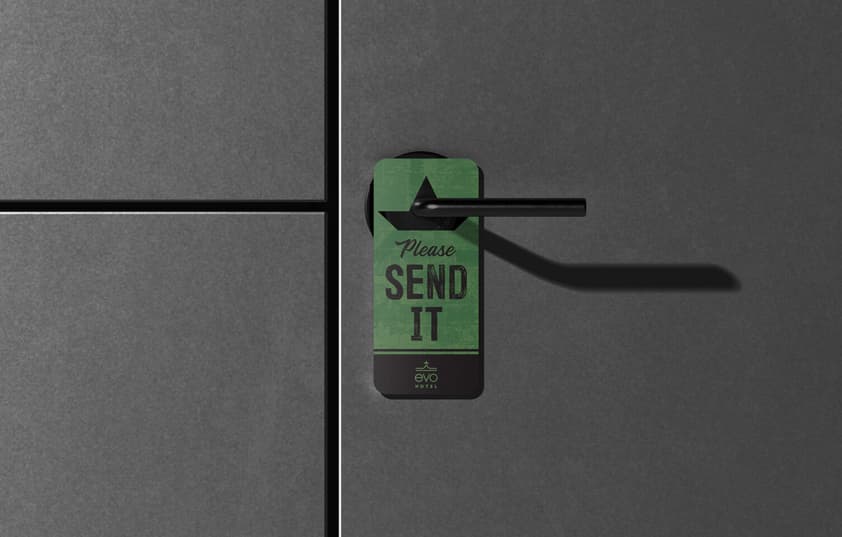 A door hanger with text that reads "Please Send It"