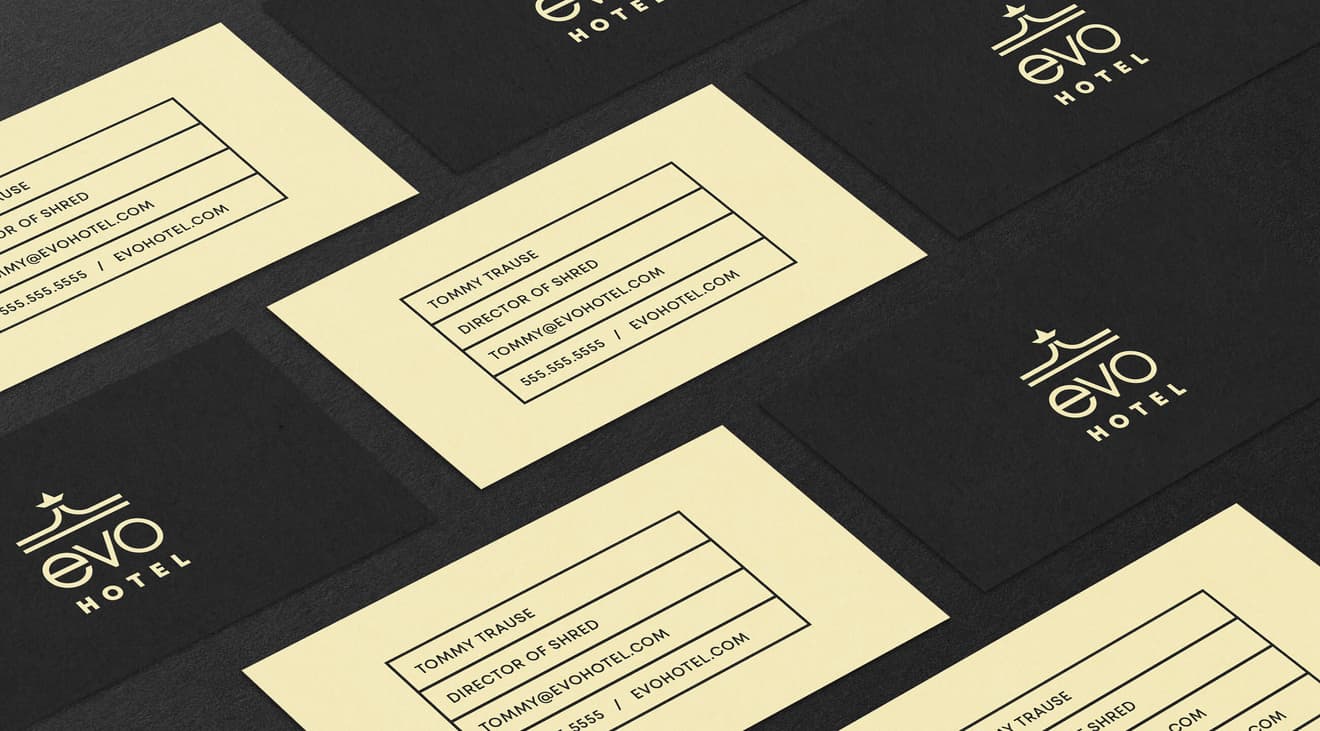 A grid of black and tan EVO Hotel business cards.