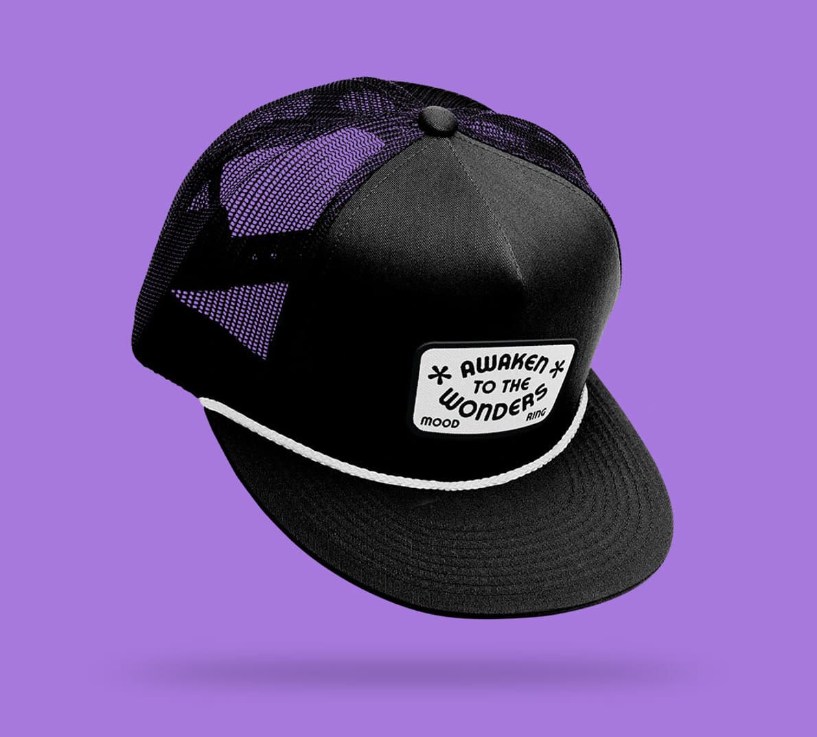 A floating hat on a purple background with a patch that reads "Awaken to the Wonders"