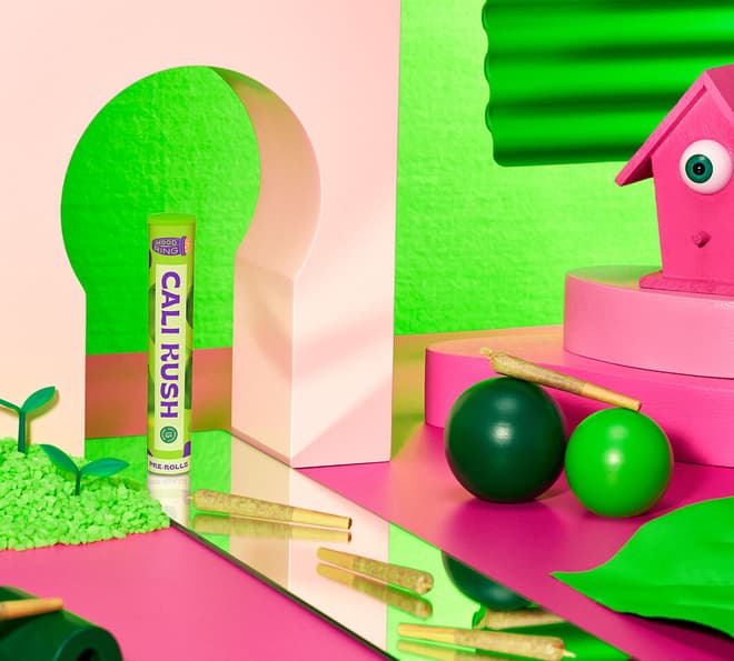 A product shot of a 'Cali Kush Pre-roll' in a scene with bright green and pink colors and various shapes.