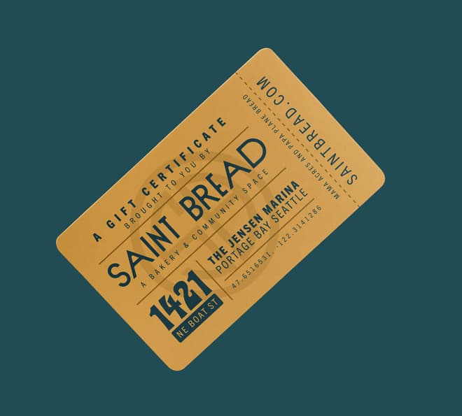 A yellow Saint Bread gift card on a green background.