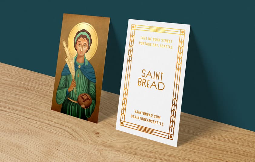 Two Saint Bread business cards side by side showing the front and back designs.